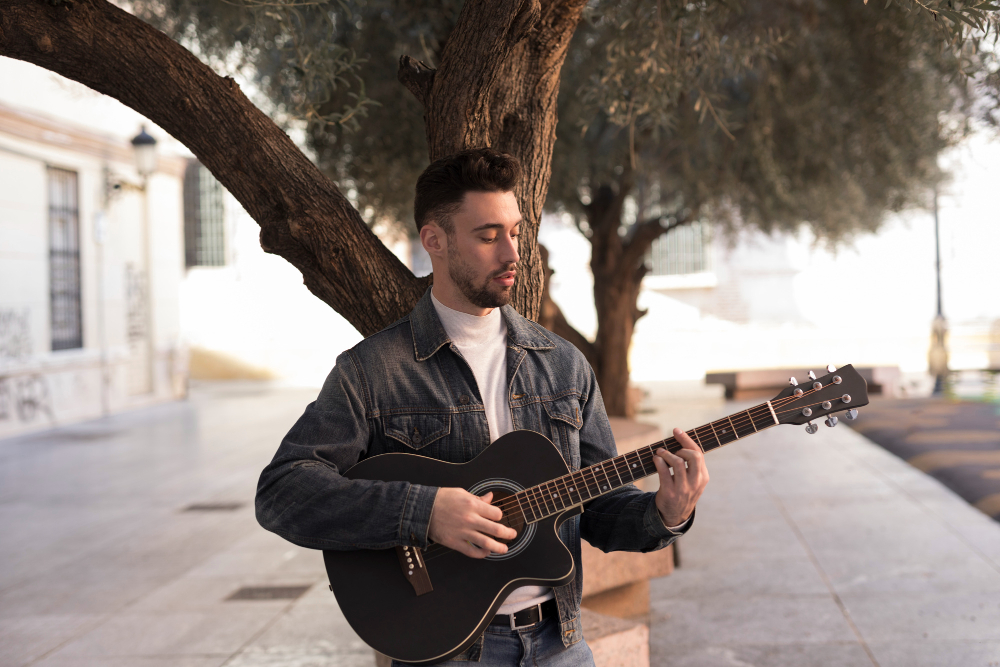 man playing guitar in public